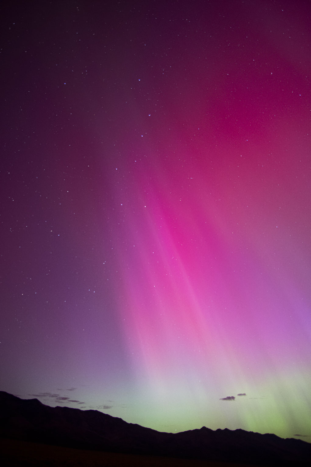 Pink aurora pillars up to the big dipper